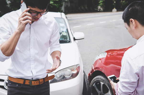 Car accident scene with damaged vehicles, representing why you may should i get a lawyer after a car accident for legal support.