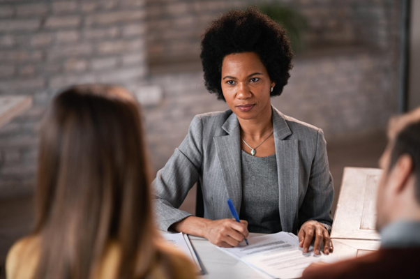 Solicitor meeting clients and reviewing documents, representing a personal injury solicitor consultation.