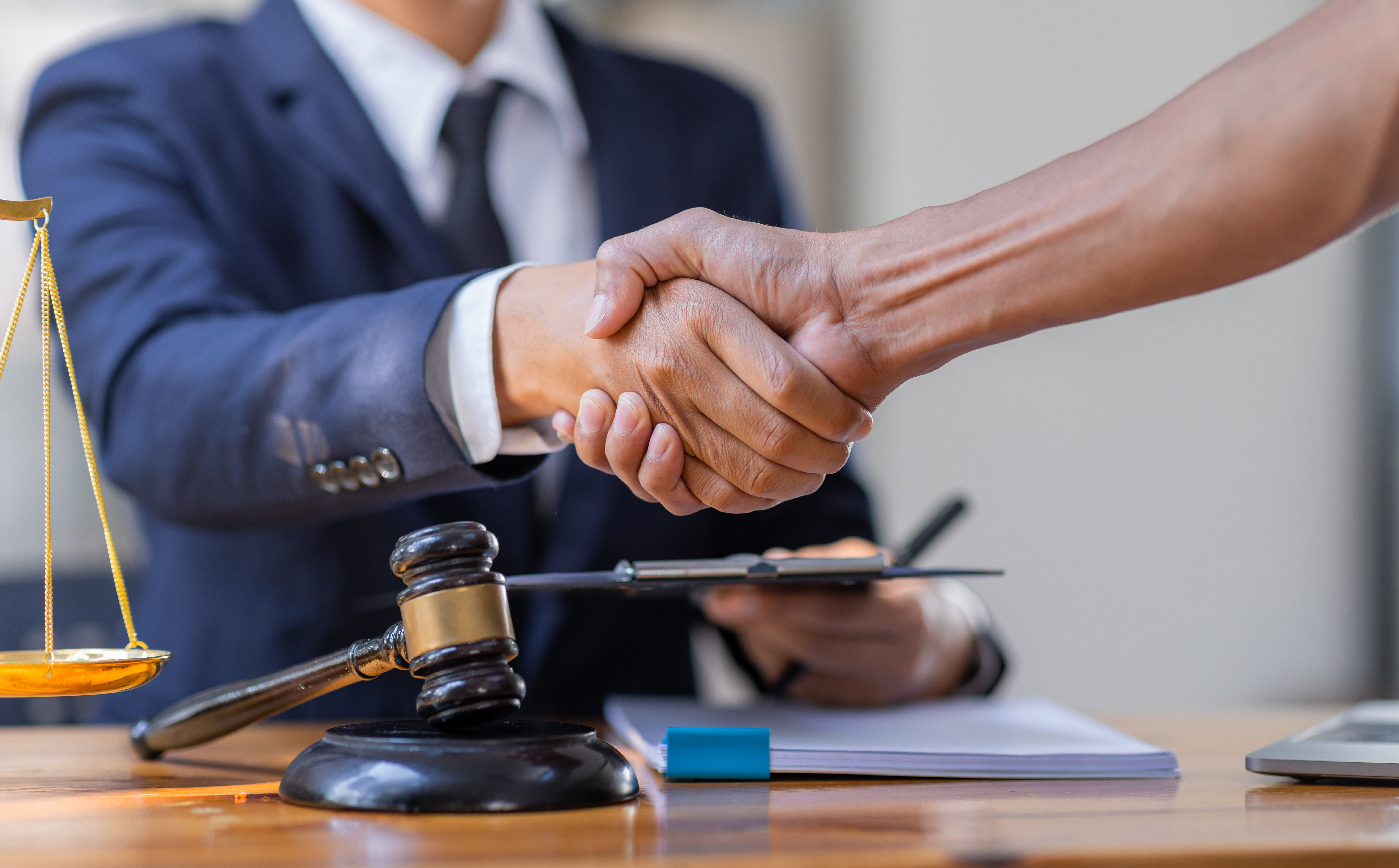 Client shaking hands with a solicitor, changing lawyers during a car accident case.